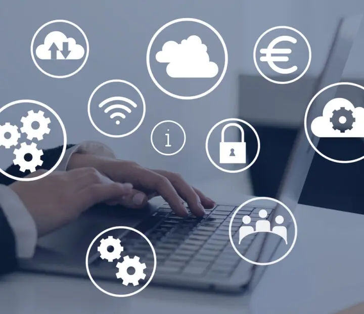 Hands working with a laptop. Business icons are illustrated above the image.