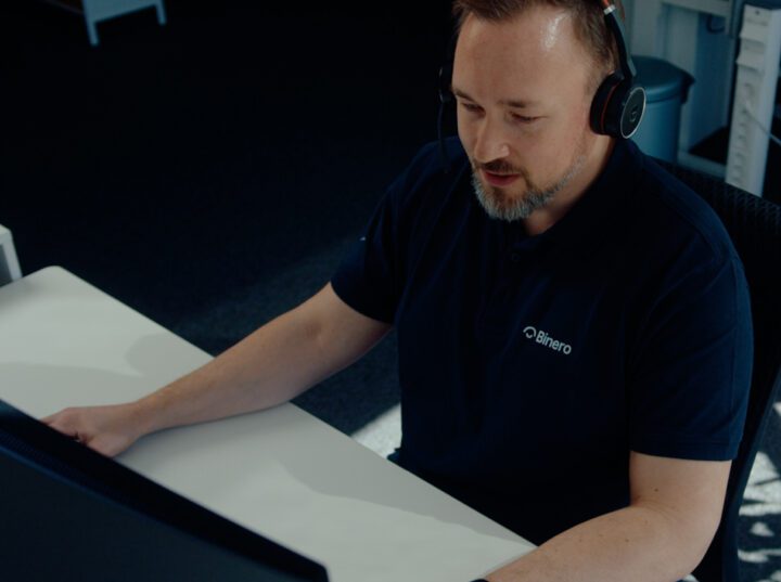 Person working with headphones at a computer