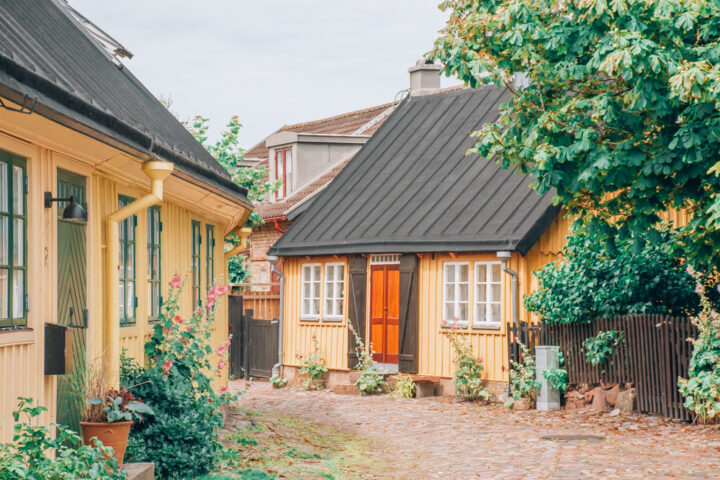 Charming yellow cottages with hollyhocks at Hotel Torekov