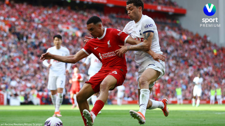 Two football players chasing the ball