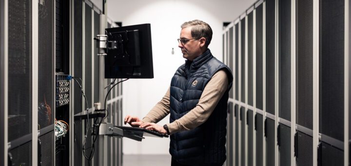 An IT technician works at a computer in Binero's data centre.