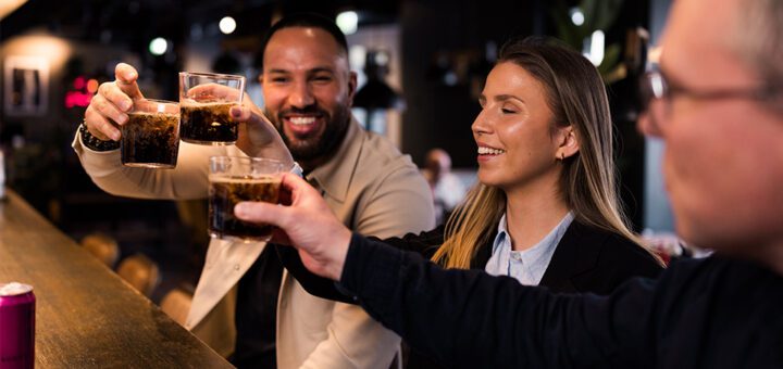 Three people toasting in a bar