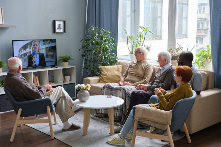 Elderly people watching TV in a nursing home