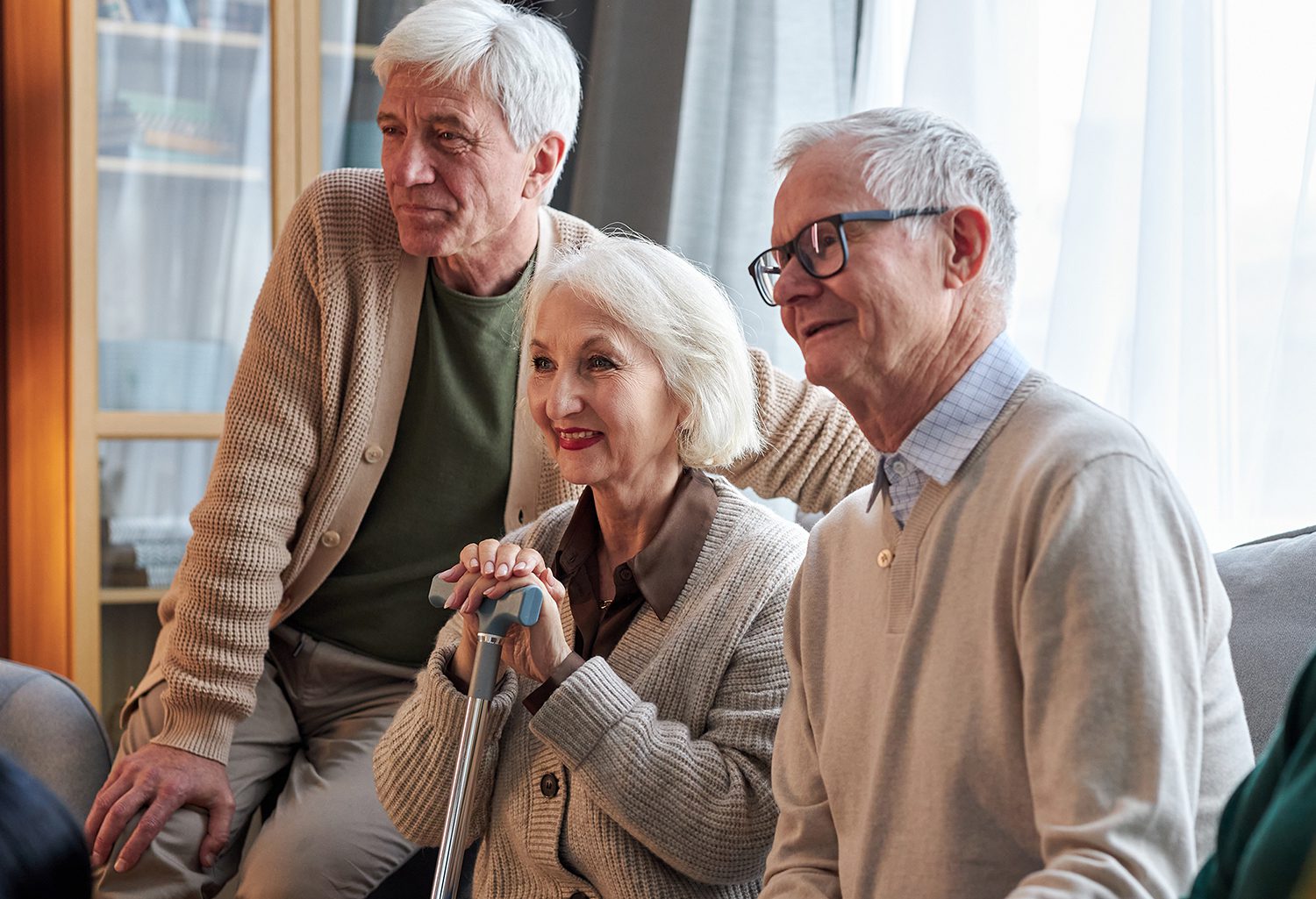 Three pensioners watching TV together