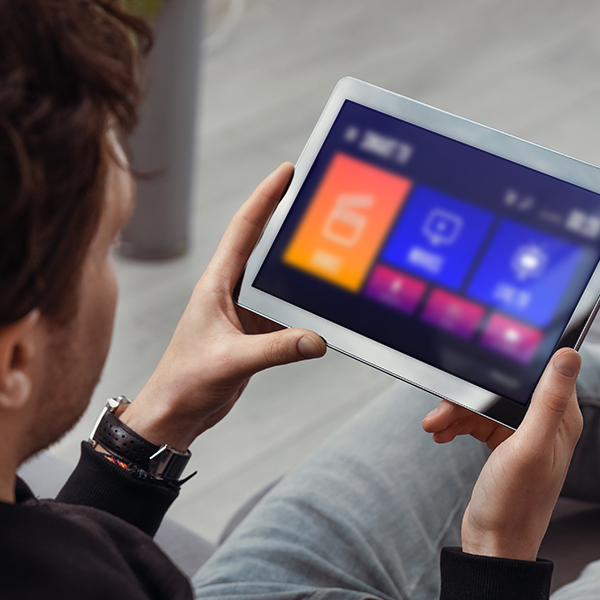 Person selecting a film to stream on a tablet