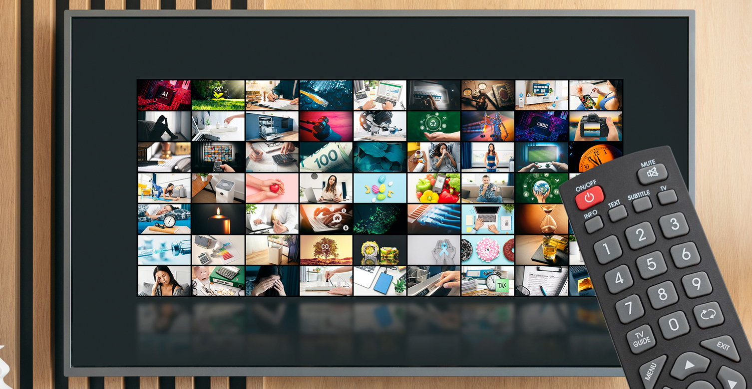 A TV shows many small thumbnail images of various programmes, with a remote control in the foreground.