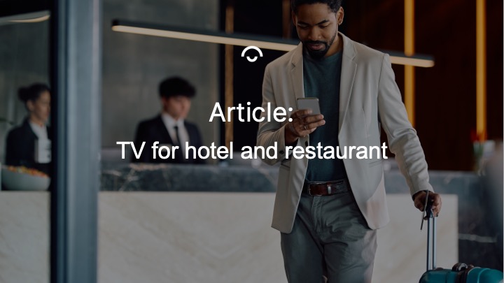 Man vid hotellreception tittar på mobil, håller väska. Text: "Article: TV for hotel and restaurant".